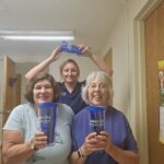 UCHRA Public Transportation employees pose with blue tumblers, featuring the UCHRA Public Transportation logo.